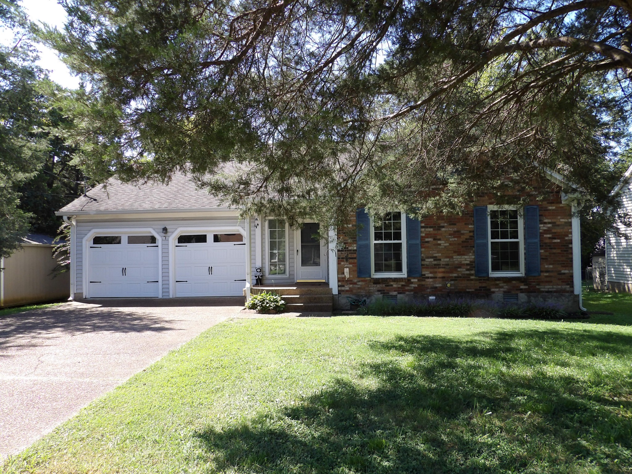 317 Cedarcliff Road Antioch, TN 37013 - Photo 4 of 31 a front view of a house with a yard and garage