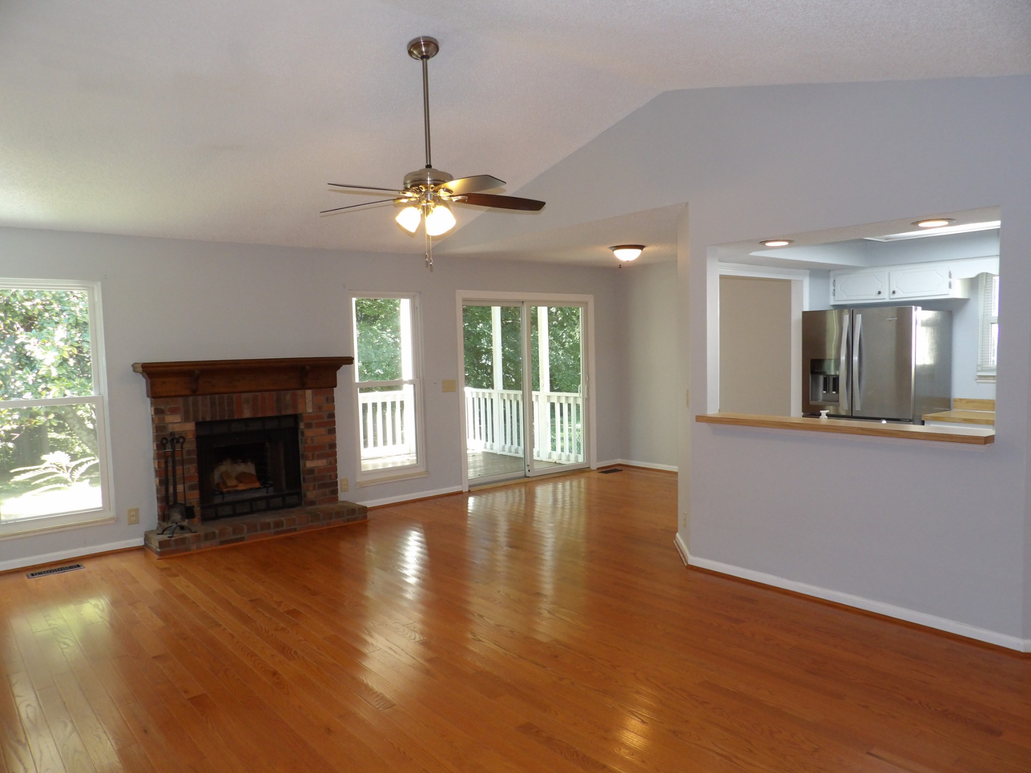 317 Cedarcliff Road Antioch, TN 37013 - Photo 5 of 31 a view of an empty room with wooden floor fireplace and a window