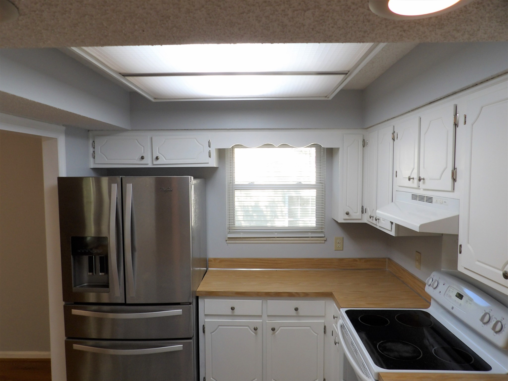 317 Cedarcliff Road Antioch, TN 37013 - Photo 9 of 31 a kitchen with a refrigerator and white cabinets