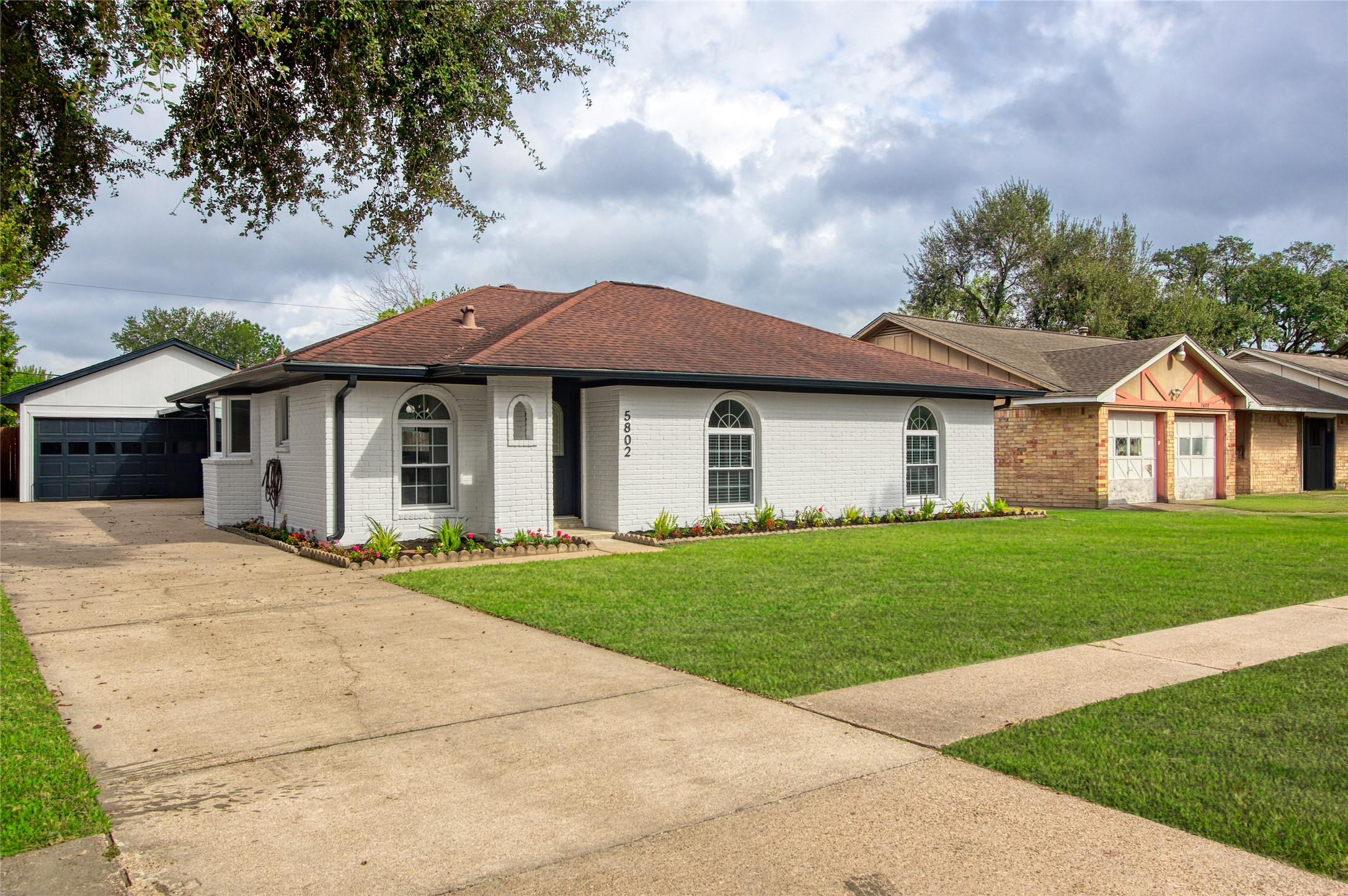 5802 Chrystell Lane Houston, TX 77092 - Photo 1 of 17 a front view of a house with a garden