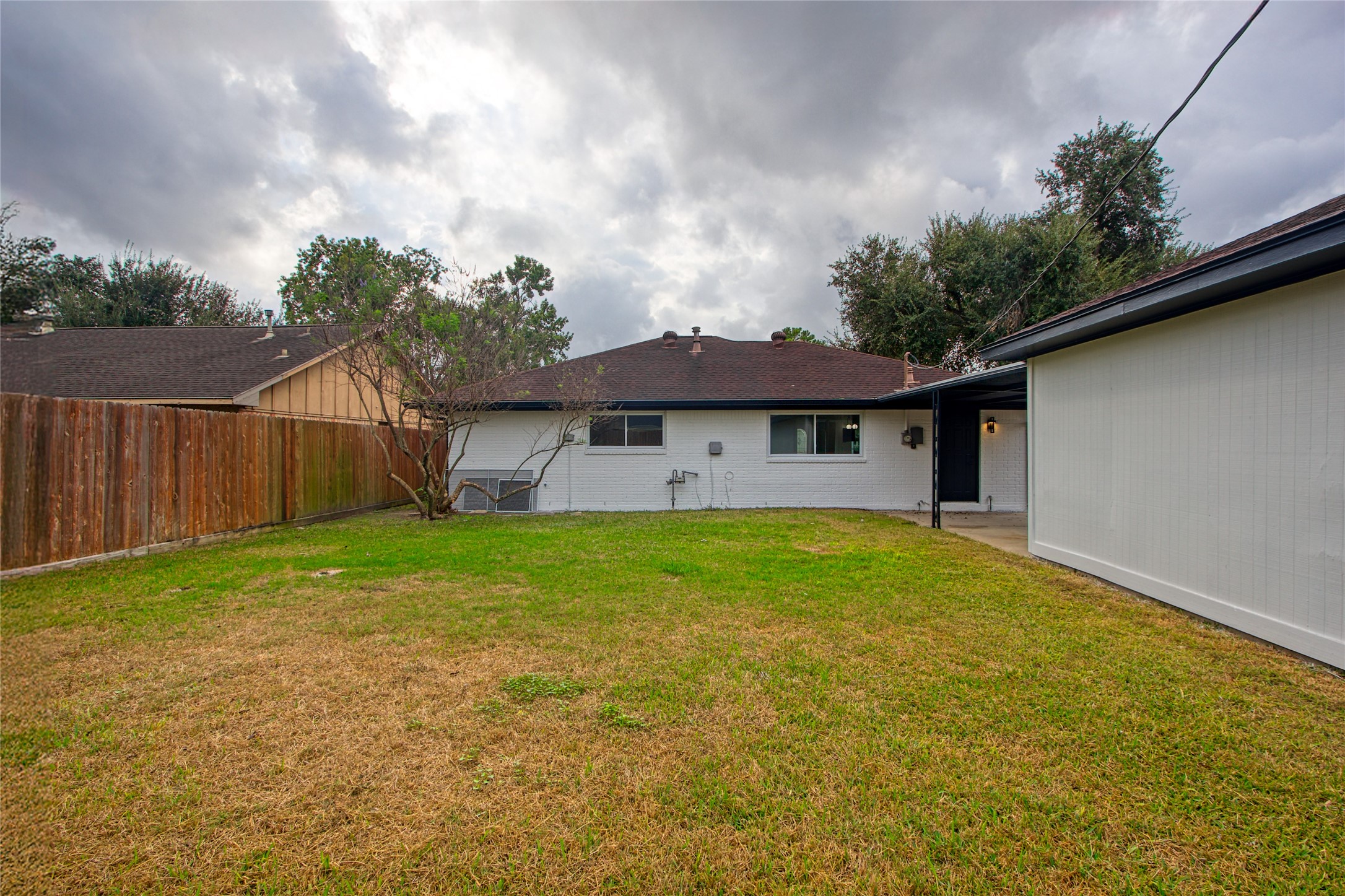 5802 Chrystell Lane Houston, TX 77092 - Photo 16 of 17 a view of a house with a yard