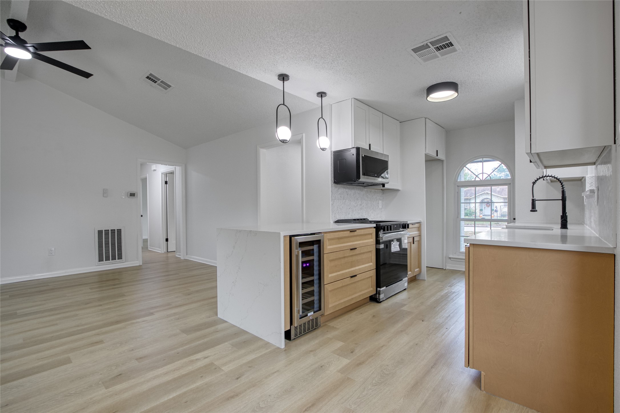 5802 Chrystell Lane Houston, TX 77092 - Photo 3 of 17 a kitchen with stainless steel appliances a stove top oven a sink and a refrigerator
