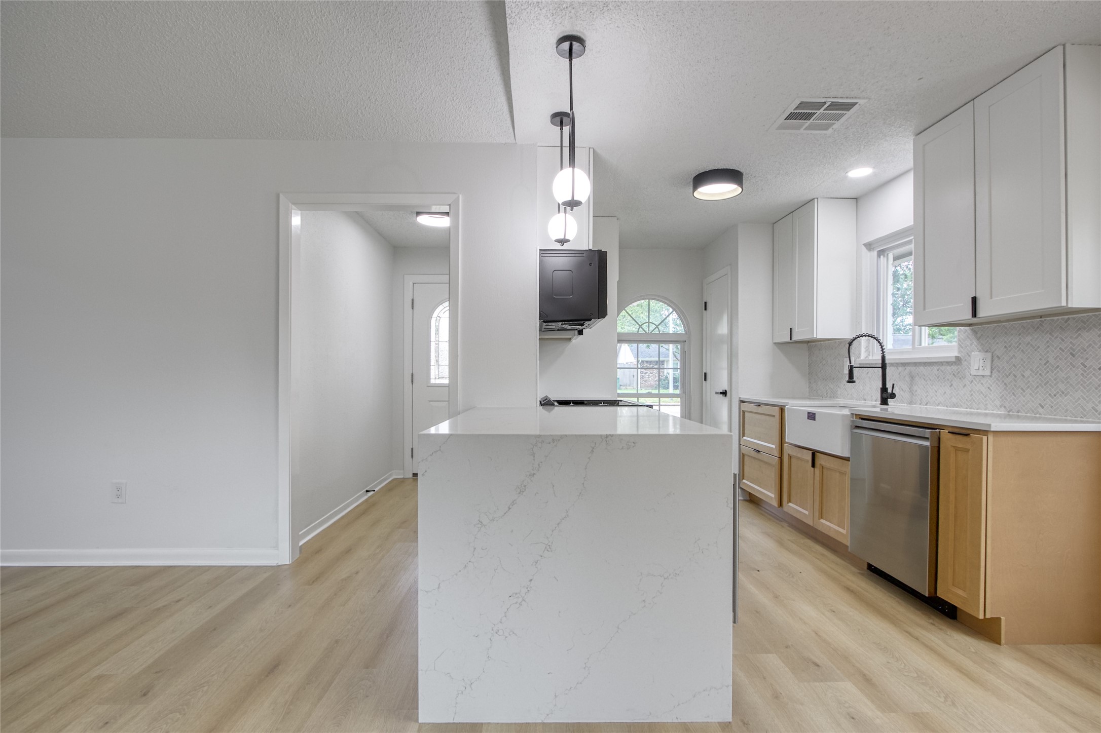 5802 Chrystell Lane Houston, TX 77092 - Photo 5 of 17 a large kitchen with granite countertop a large counter top a sink stainless steel appliances and cabinets