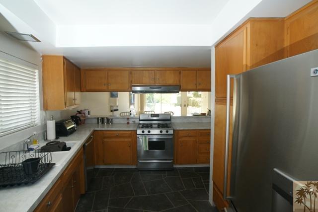 1855 Ramon Road, Unit 29 Palm Springs, CA 92264 - Photo 16 of 24 a kitchen with stainless steel appliances granite countertop a sink stove and refrigerator