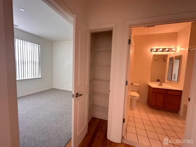 walk in closet and a bathroom