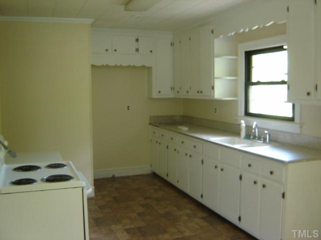 3510 Cheek Road Durham, NC 27704 - Photo 2 of 5 a room with a sink a stove and a window