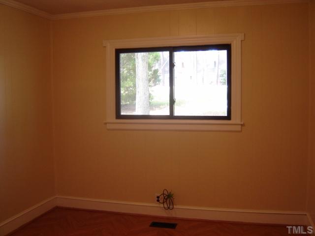 3510 Cheek Road Durham, NC 27704 - Photo 5 of 5 a view of a small space with wooden floor and a window