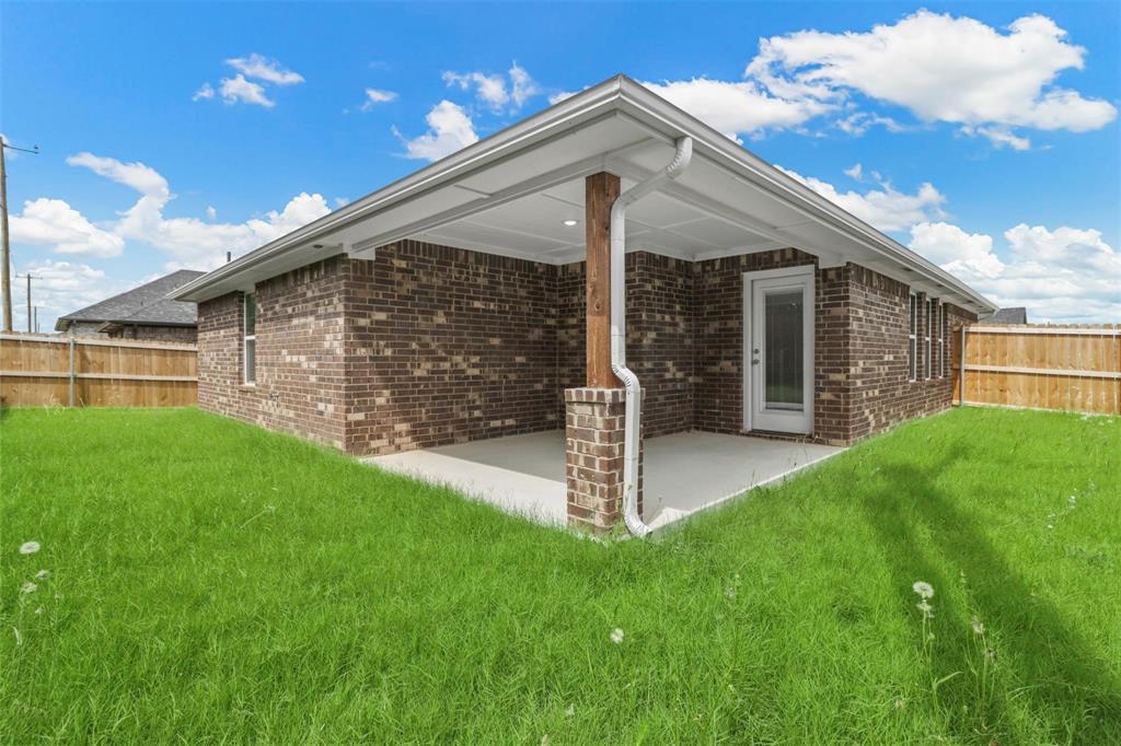 1601 Aleia Cove Sherman, TX 75092 - Photo 15 of 16 Back of property featuring a patio and brick siding