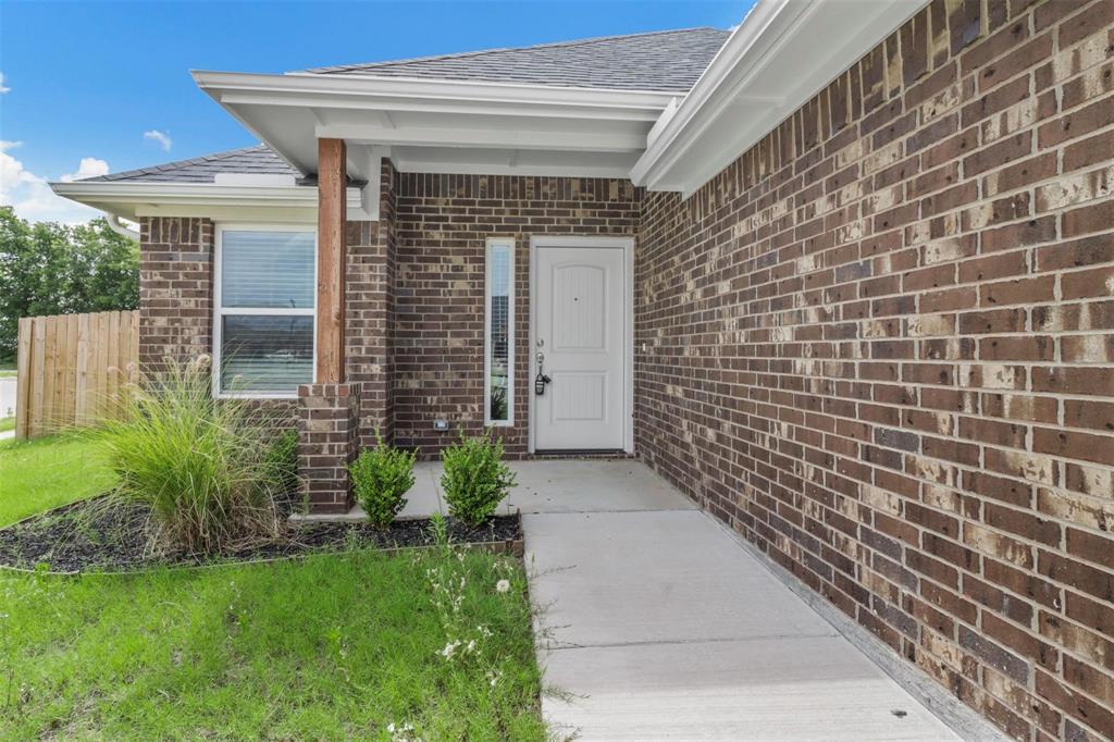 1601 Aleia Cove Sherman, TX 75092 - Photo 2 of 16 Property entrance with brick siding and a shingled roof