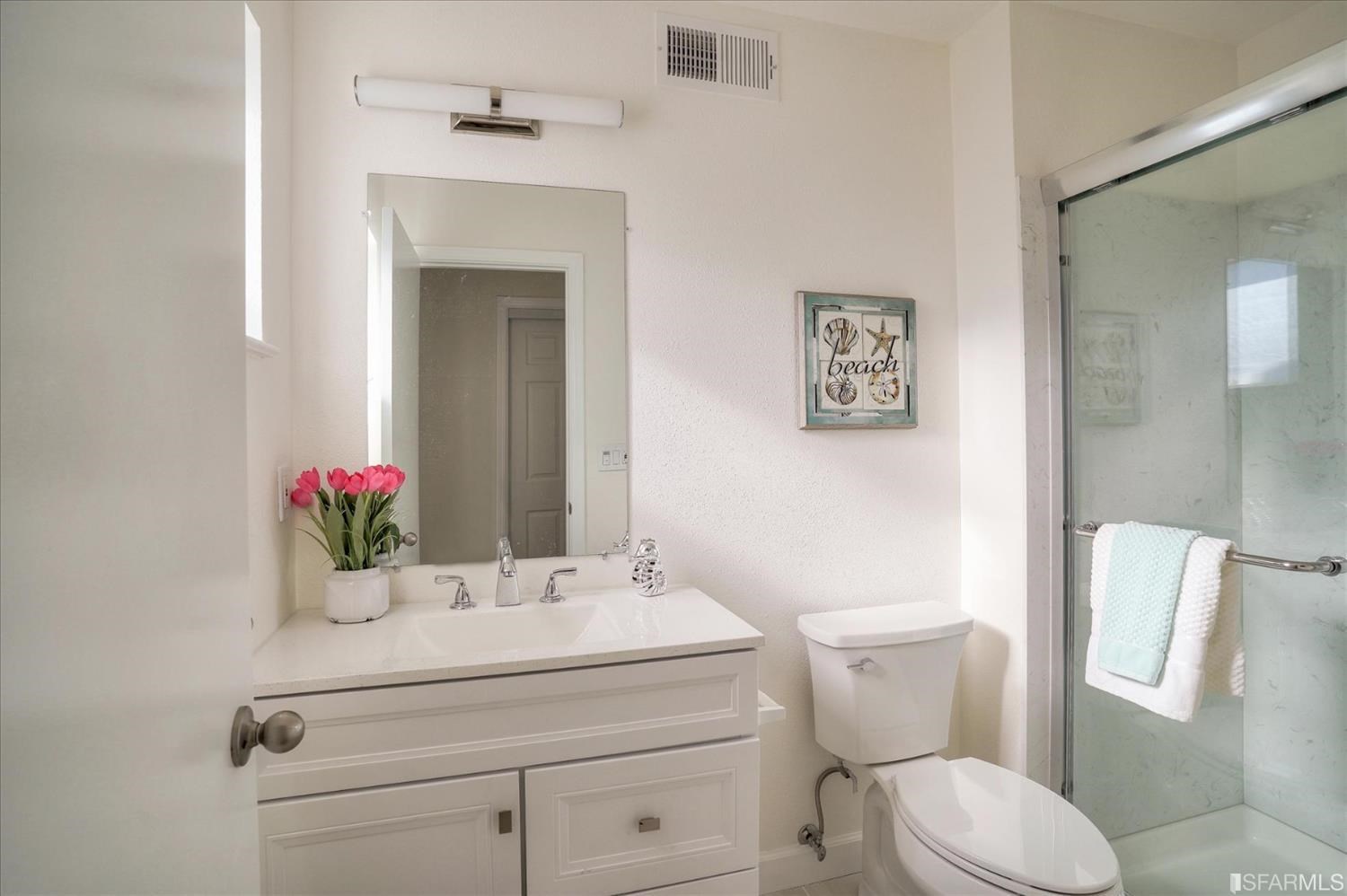 3419 May Road Richmond, CA 94803 - Photo 33 of 38 a bathroom with a sink vanity mirror and toilet