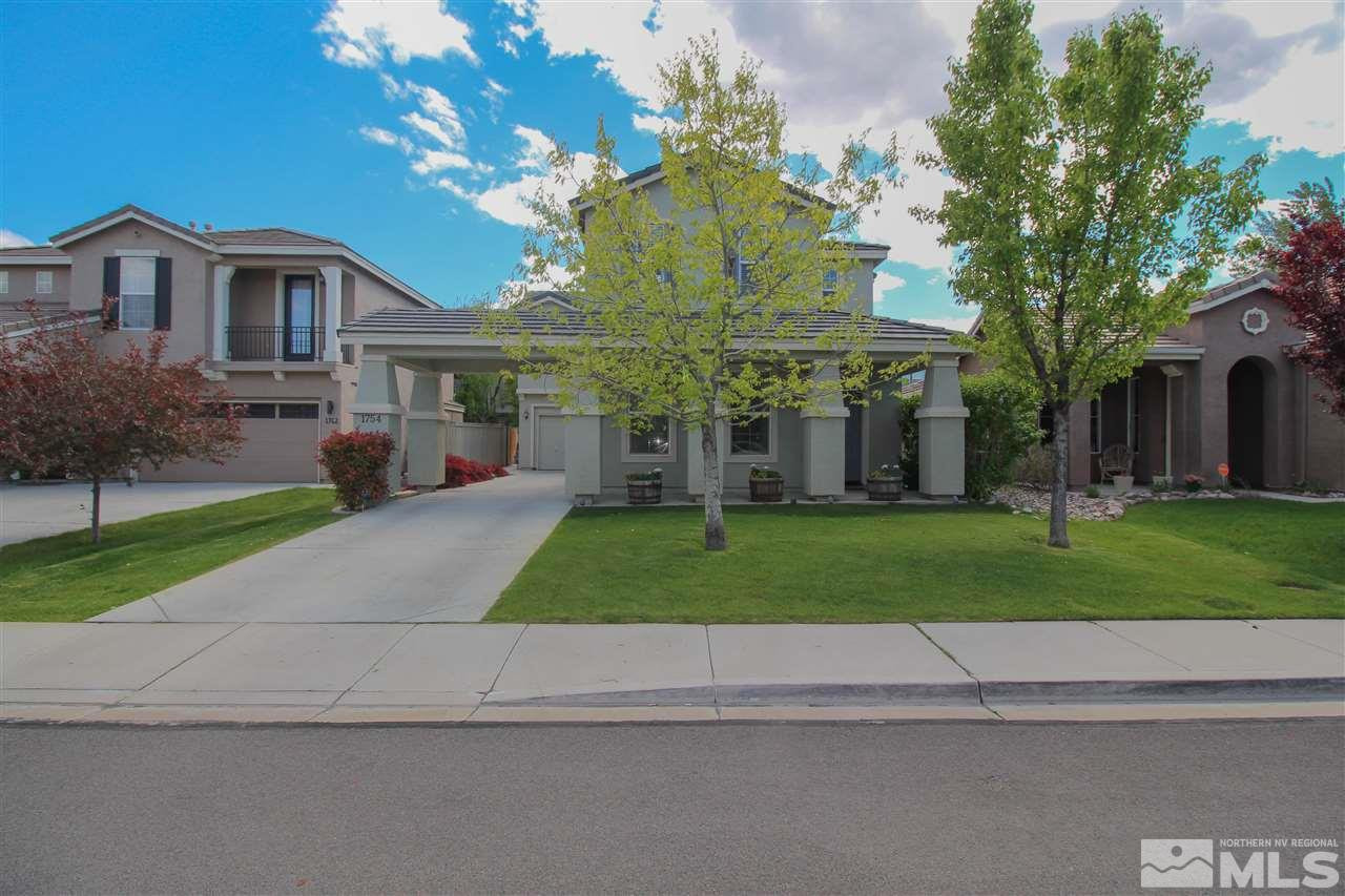 1754 Cavern Drive Reno, NV 89521 - Photo 1 of 1 a view of a white house next to a yard and large trees