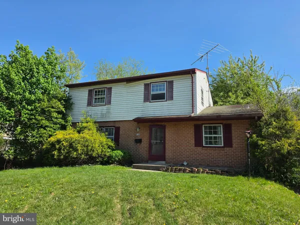 a house that has a tree in front of it