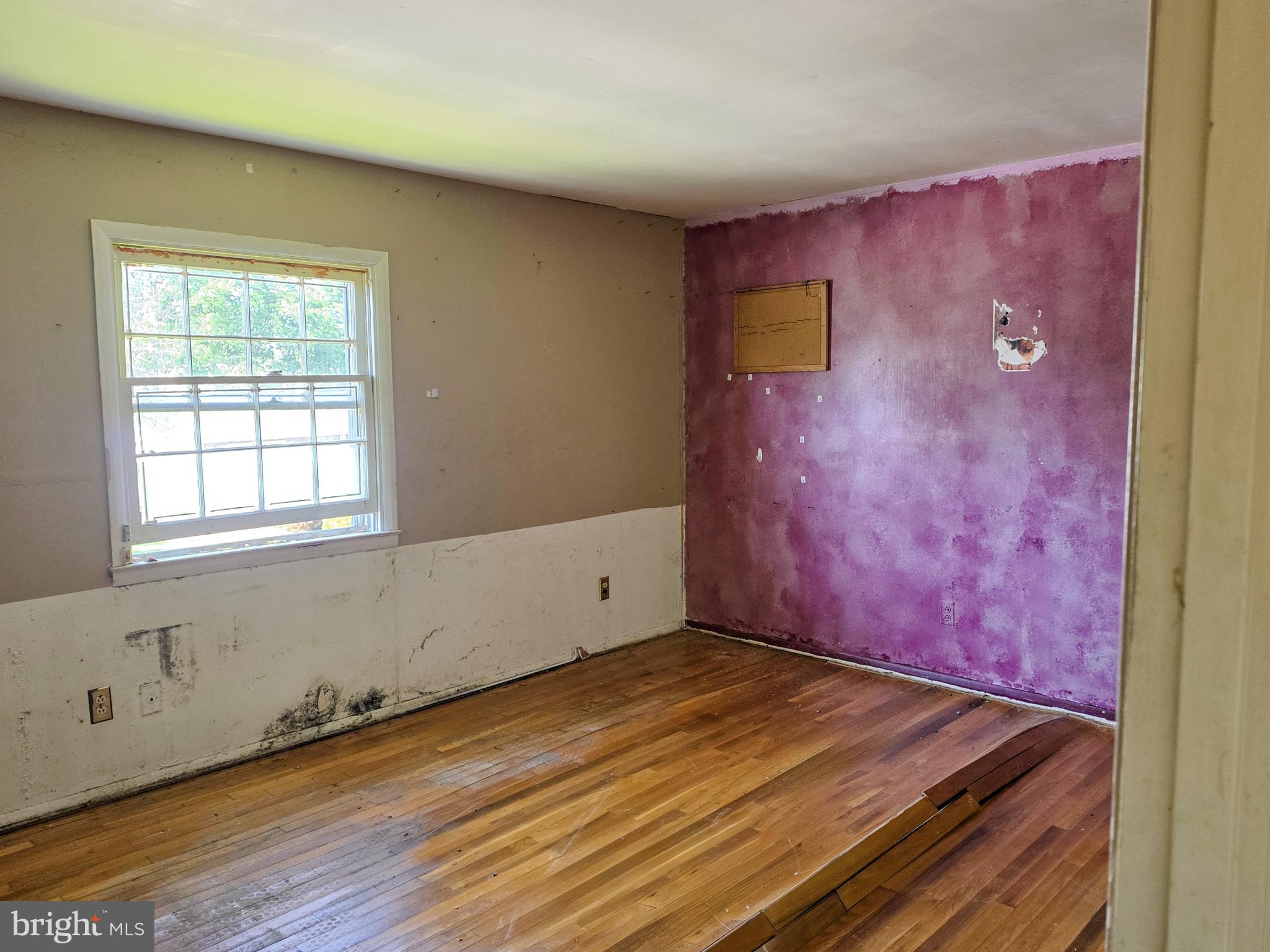 109 Cherry Valley Road Reisterstown, MD 21136 - Photo 17 of 23 an empty room with wooden floor and windows