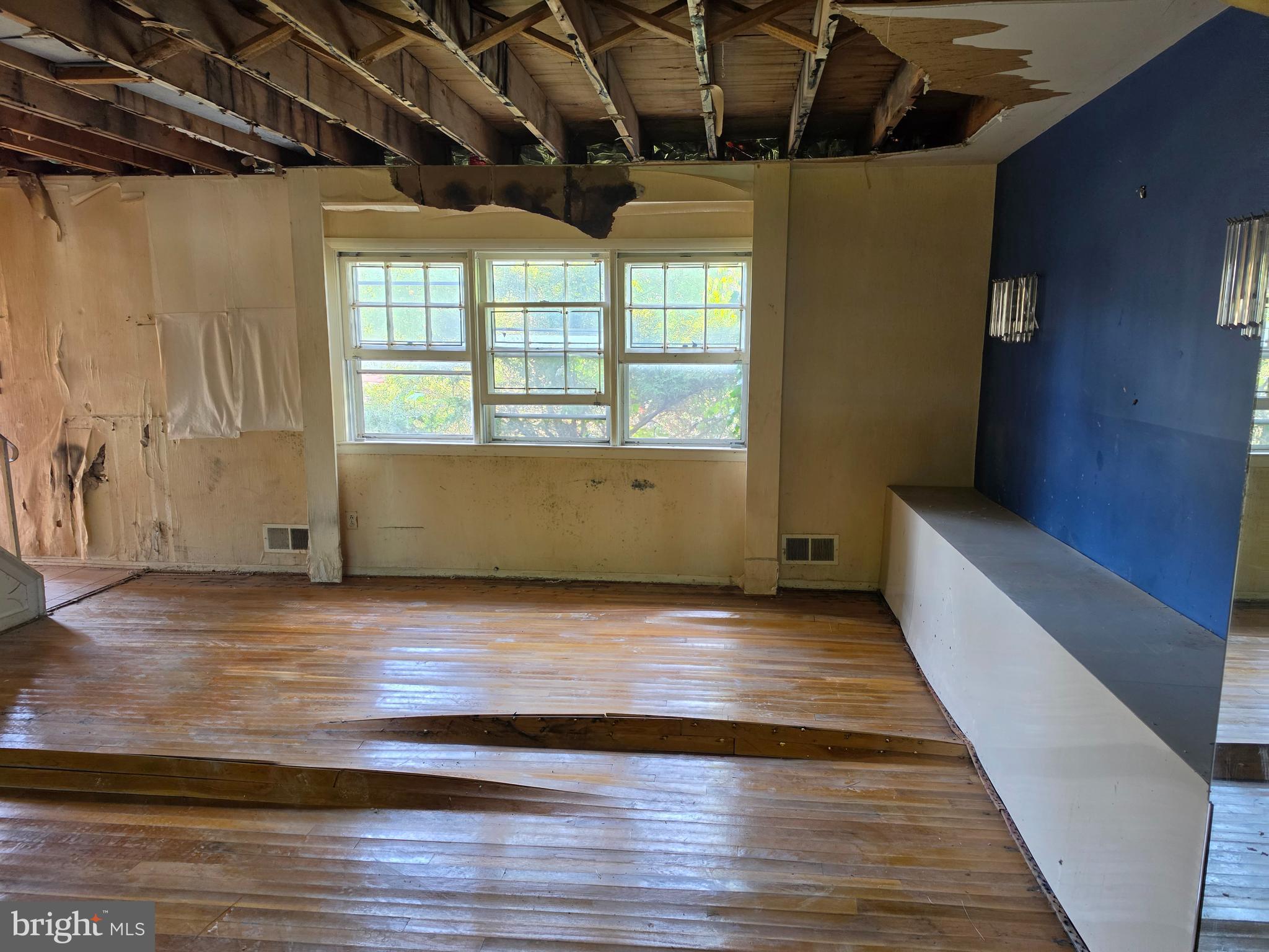109 Cherry Valley Road Reisterstown, MD 21136 - Photo 5 of 23 a view of an empty room with wooden floor and a window