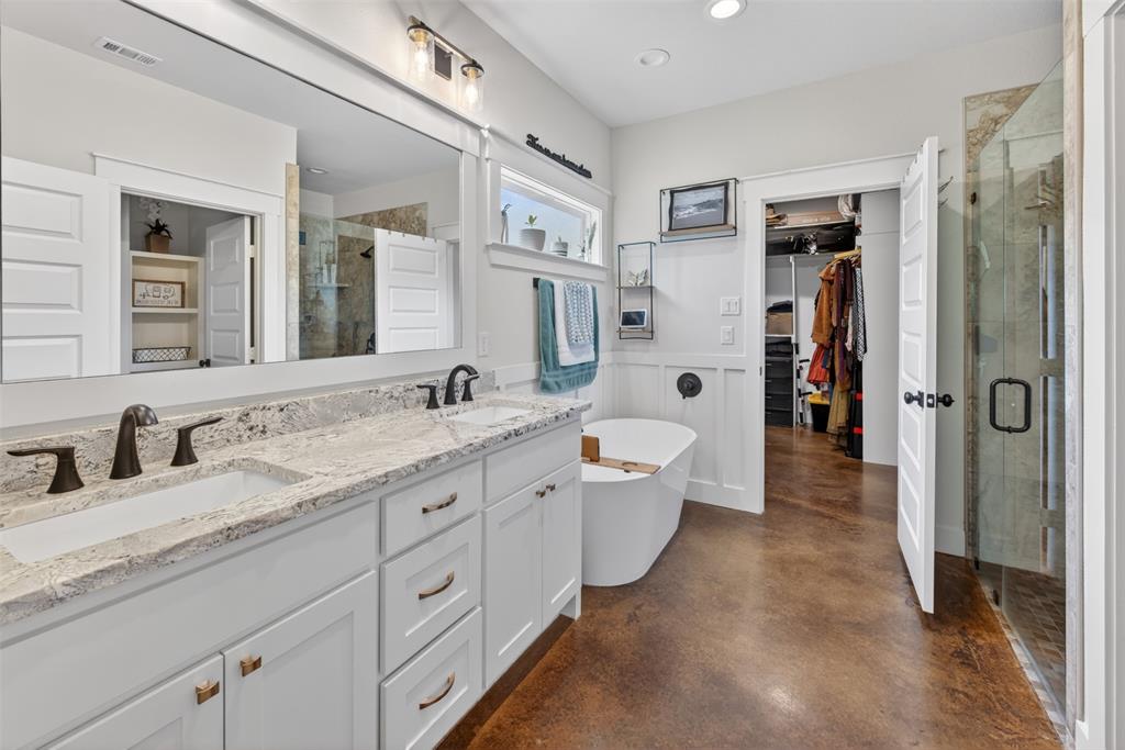 6371 Mill Run Road Athens, TX 75751 - Photo 14 of 40 The bathroom features a double vanity with granite countertops, a freestanding bathtub, and a glass-enclosed shower