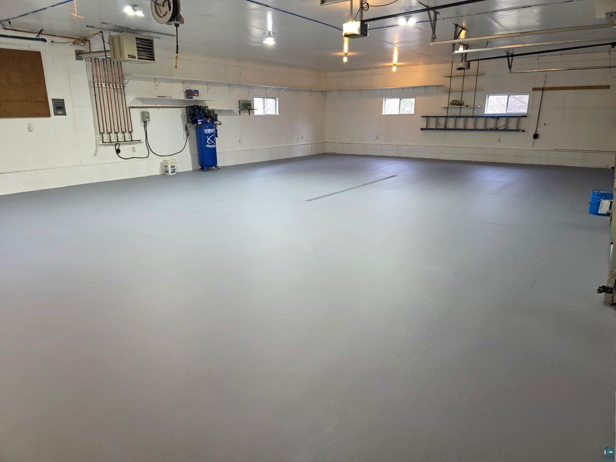 11702 East Mail Road Gordon, WI 54838 - Photo 17 of 49 Expansive garage with a light gray finished floor