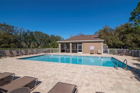 a view of house with backyard outdoor seating and entertaining space