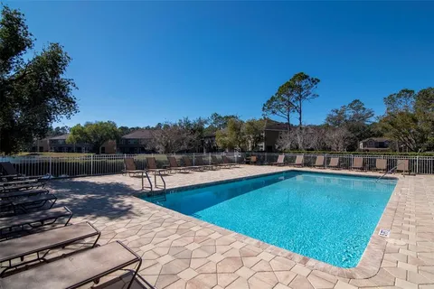 a view of a swimming pool with a lounge chair