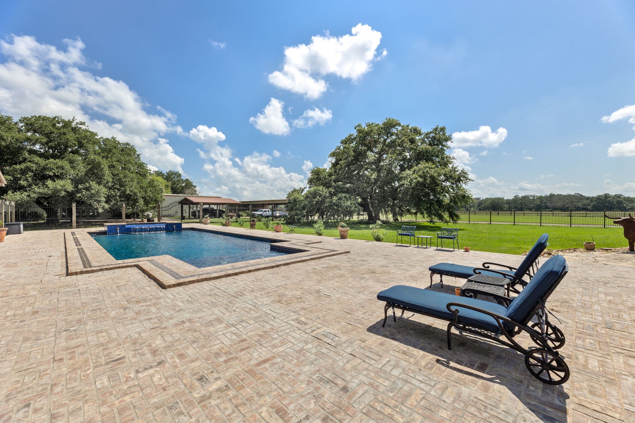 1226 County Road 45 Angleton, TX 77515 - Photo 6 of 30 a view of a terrace with chairs and a fire pit