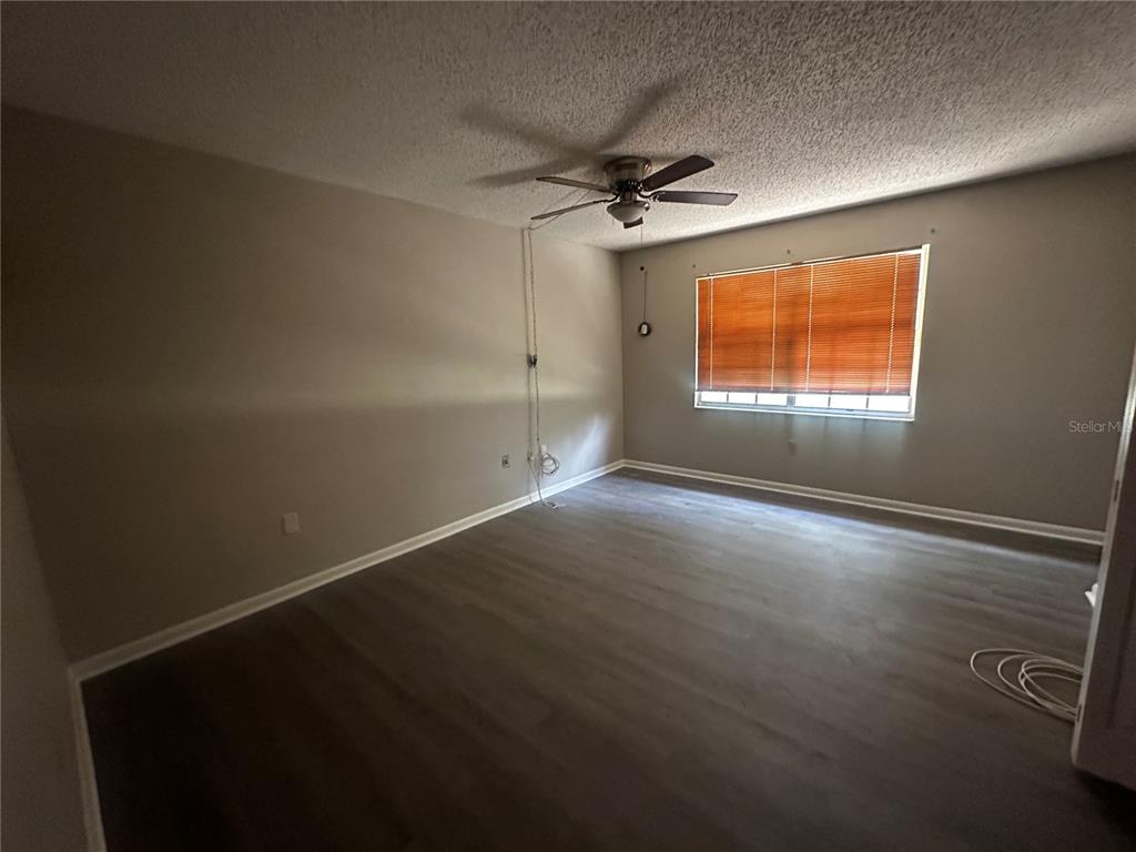 66 Silver Lane Ocala, FL 34472 - Photo 6 of 10 an empty room with a window and a ceiling fan