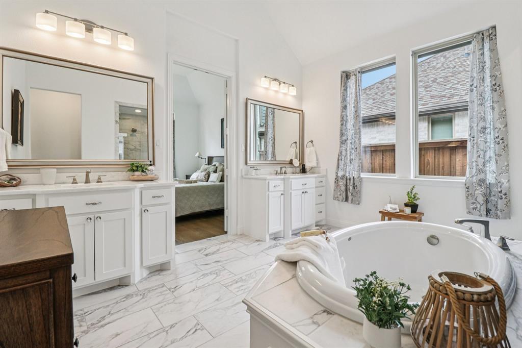 8277 Halifax The Colony, TX 75056 - Photo 21 of 37 a spacious bathroom with a tub sink and mirror