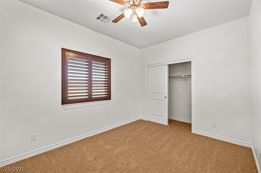 6720 Stubblefield Drive Pahrump, NV 89061 - Photo 21 of 51 A comfortable bedroom with rich wood window shutters and a convenient closet.