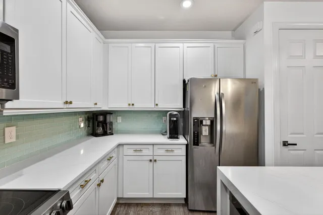 a kitchen with a refrigerator a sink and dishwasher