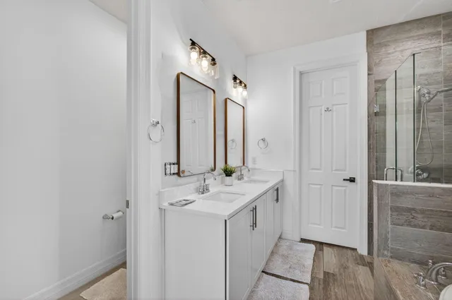a bathroom with a toilet a sink and mirror