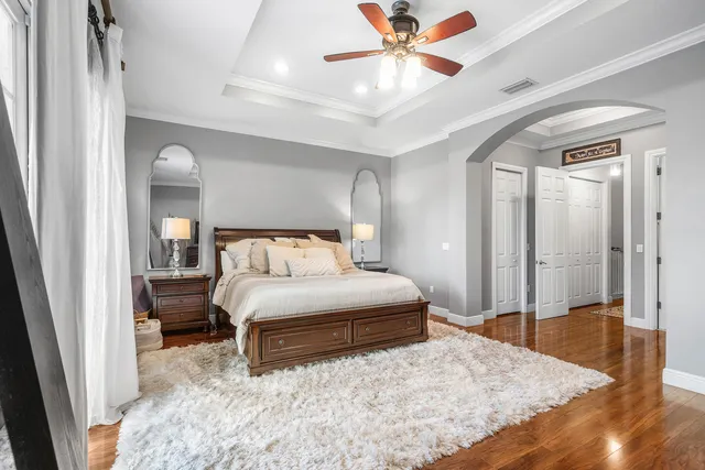 a view of walk in closet with furniture and wooden floor