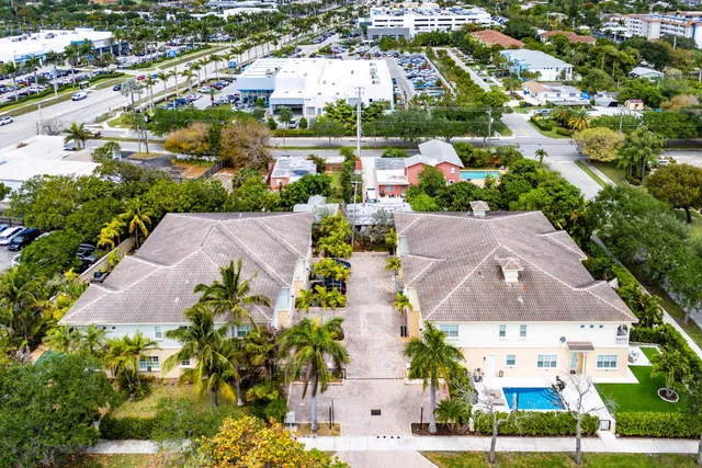 an aerial view of a house with a garden and lake view
