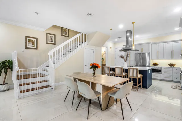 a dining room with furniture and wooden floor