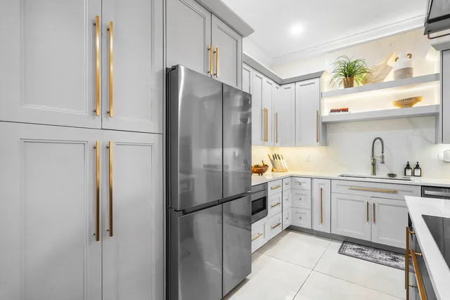 a kitchen with stainless steel appliances a refrigerator and a sink