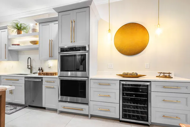 a kitchen with kitchen island granite countertop a stove and a sink