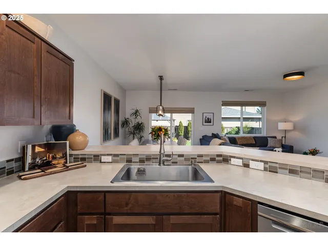 a kitchen with a sink and white cabinets