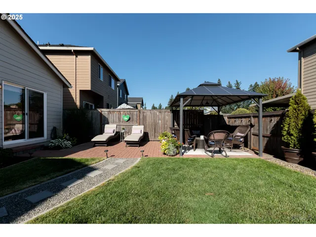 a view of a backyard with sitting area and slide