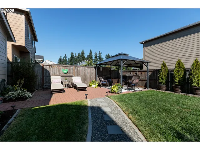 a view of a house with backyard sitting area and garden
