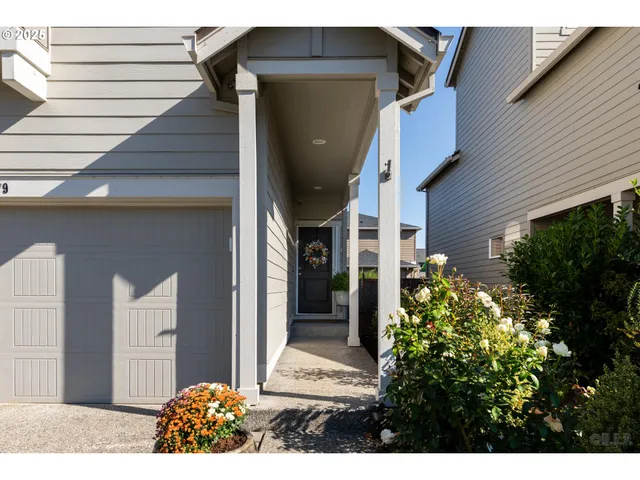a view of a house with a flower garden