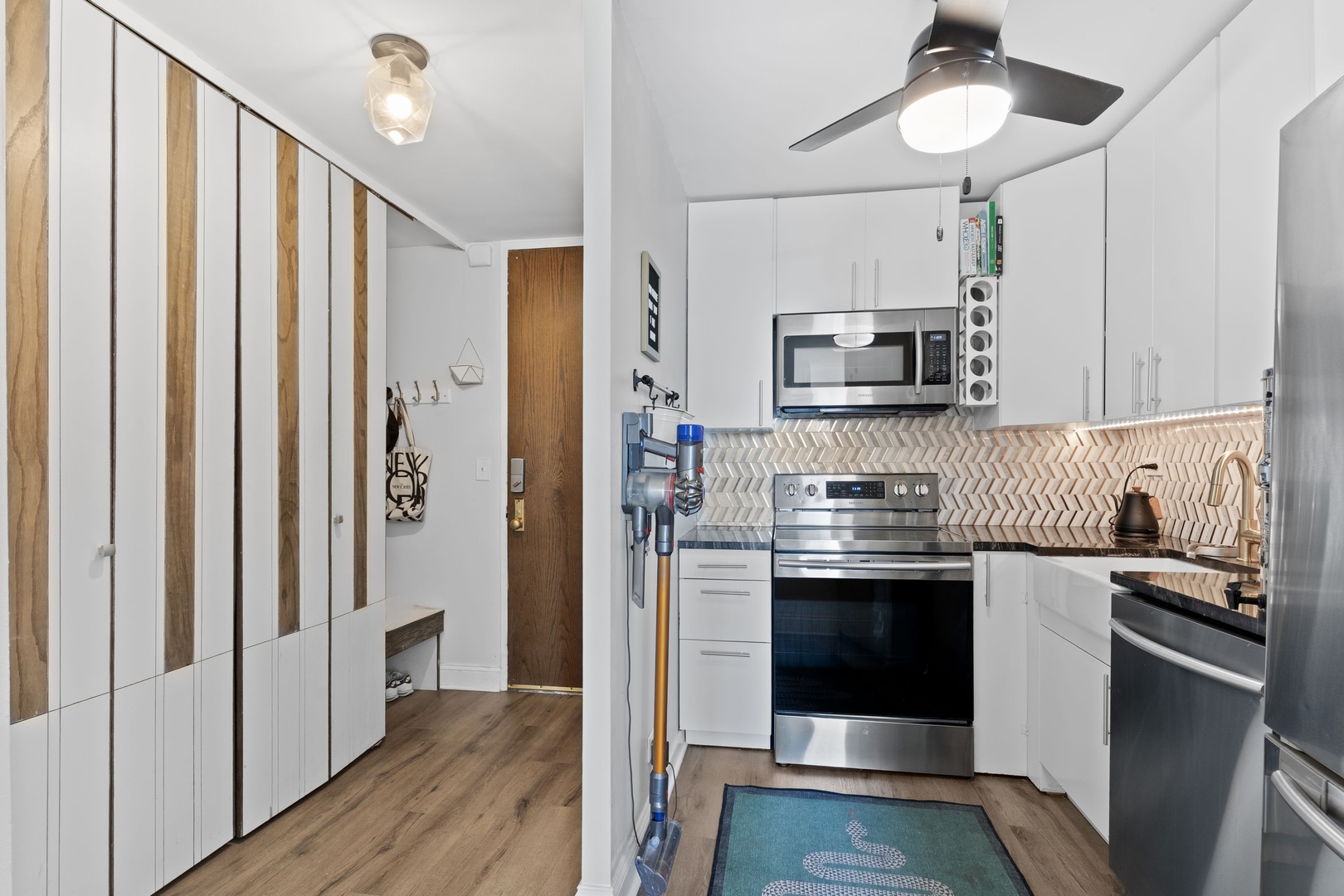 720 West Gordon Terrace, Unit 15N Chicago, IL 60613 - Photo 7 of 22 a kitchen with stainless steel appliances a stove a sink and a refrigerator