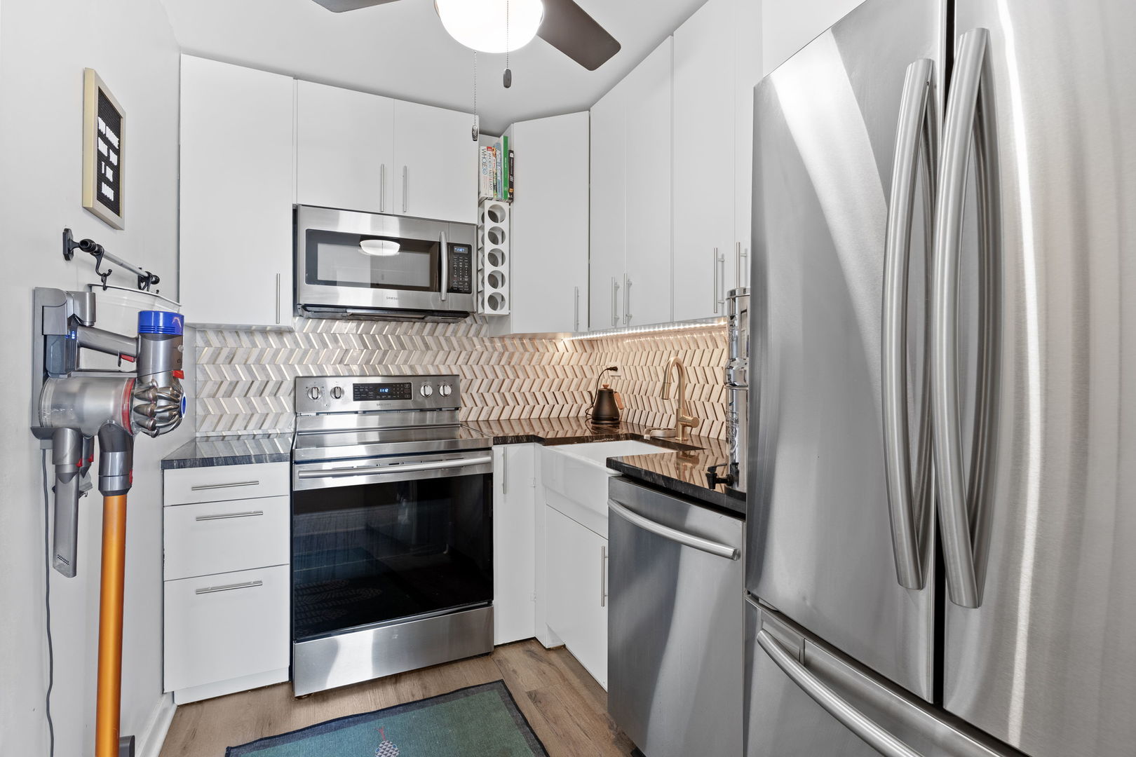720 West Gordon Terrace, Unit 15N Chicago, IL 60613 - Photo 9 of 22 a kitchen with stainless steel appliances a refrigerator stove and microwave