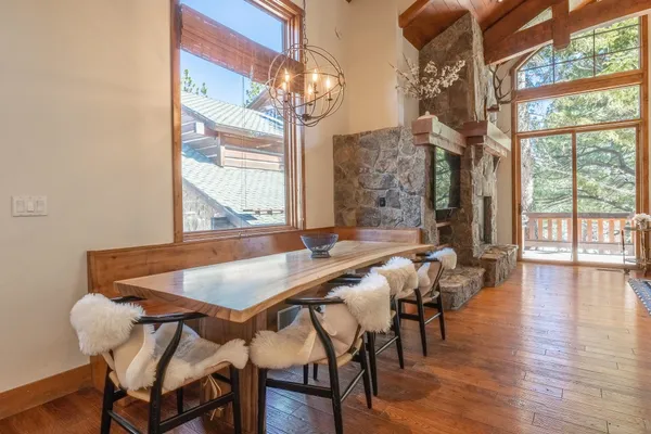a view of a dining room with furniture and chandelier