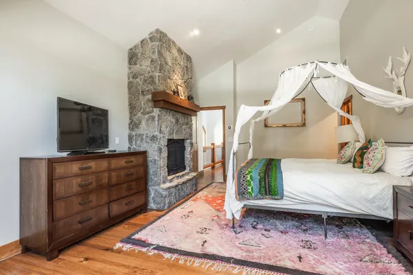 a bedroom with a bed and a mirror