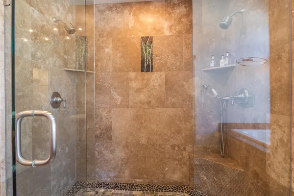 a bedroom with furniture and a large window