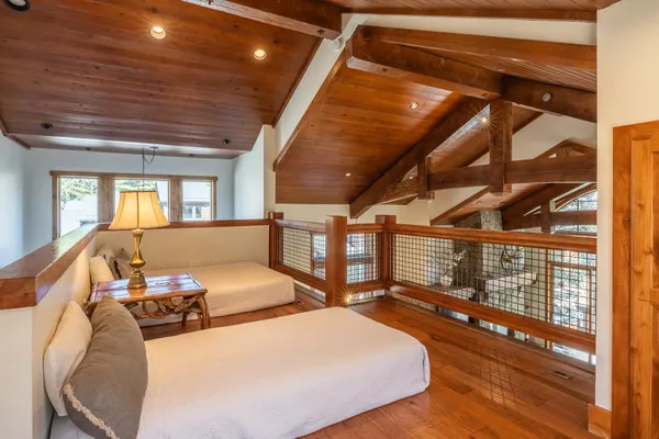 a view of staircase with wooden floor and white door