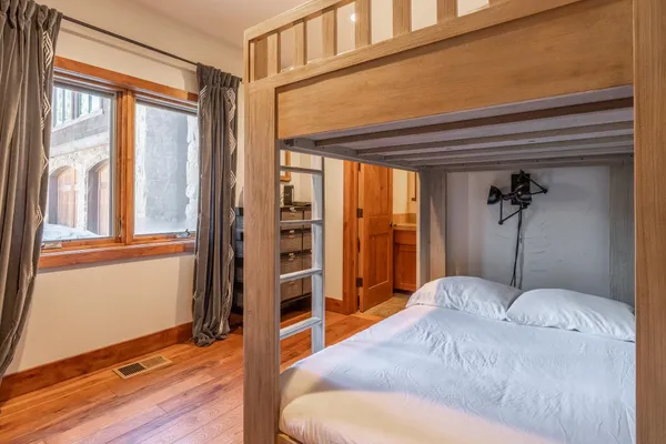a bathroom with a granite countertop sink toilet a mirror and shower