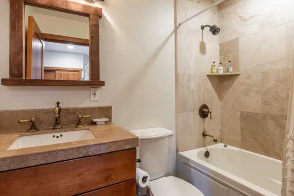 a view of a bedroom with a bed and a window