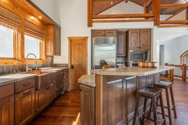 a large kitchen with lots of counter space and windows