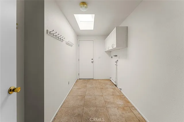 a view of a house with a large window and plants