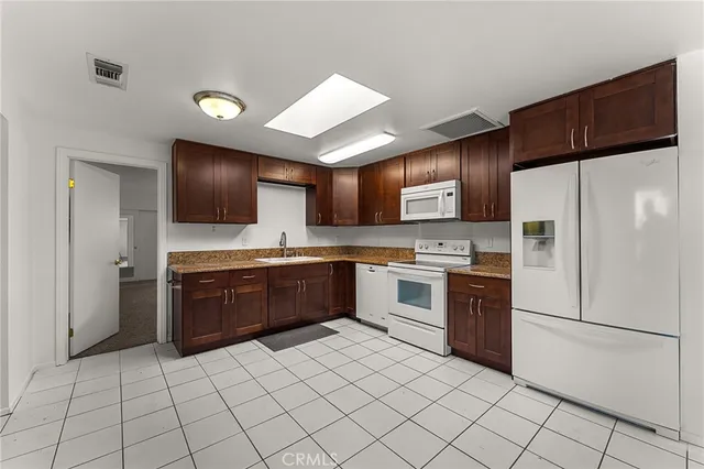 a kitchen with stainless steel appliances granite countertop a refrigerator sink and cabinets