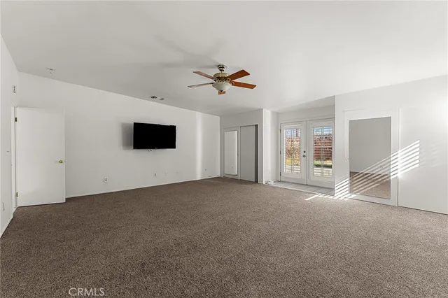 a living room with furniture and a ceiling fan