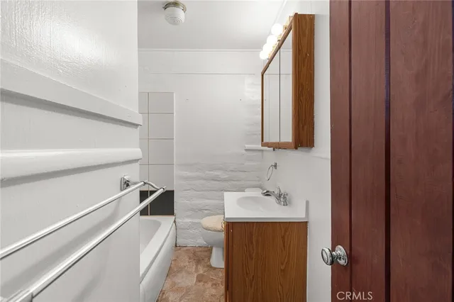 a bathroom with a sink a mirror and a bathtub
